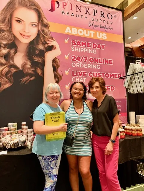 Jill Wright, Grand Prize winner Anaysia Taylor, and PinkPro Beauty Supply Marketing Manager Sheila Routon smiling together after the prize presentation.
