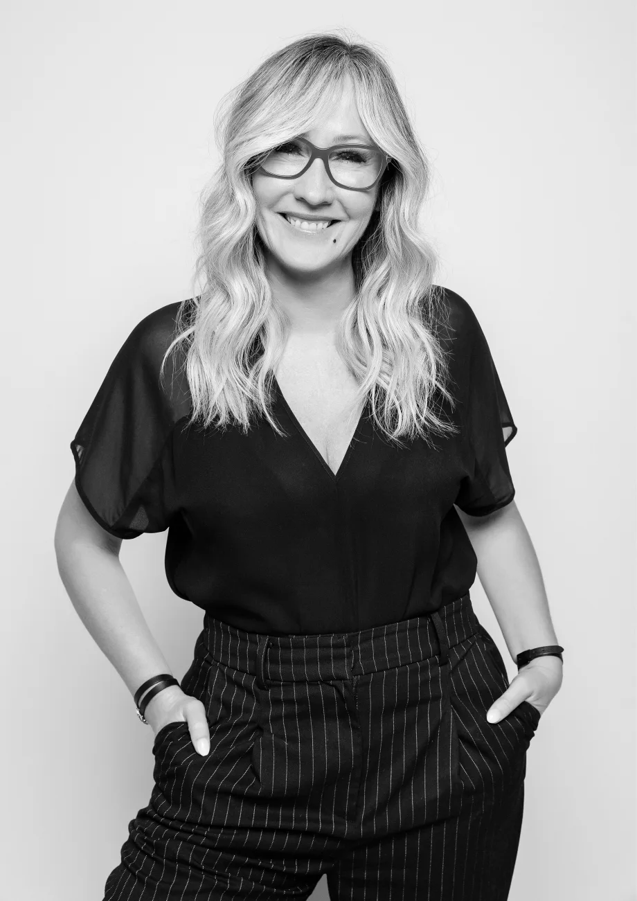 A smiling woman in glasses