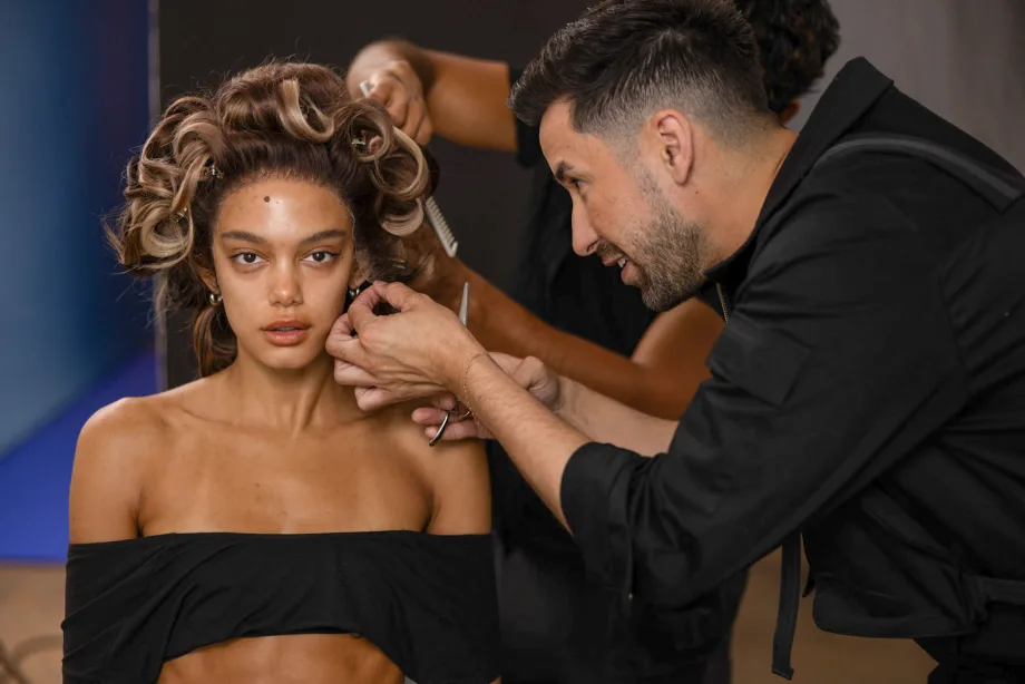 Justin Toves-Villicione adjusts a curl on a model at the Modern Salon and Ulta Beauty shoot.