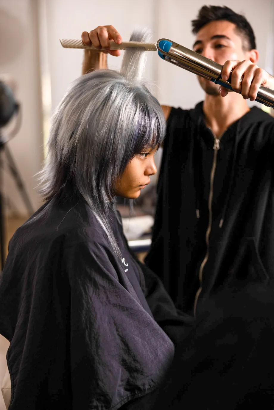 Gilad Goldstein, on set at Modern Salon photo shoot, adding curls to a silvery pixie cut.